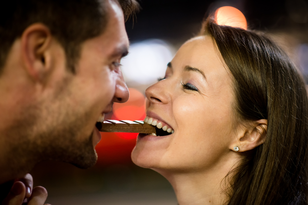 Young,Couple,Eating,Together,One,Piece,Of,Chocolate,-,In